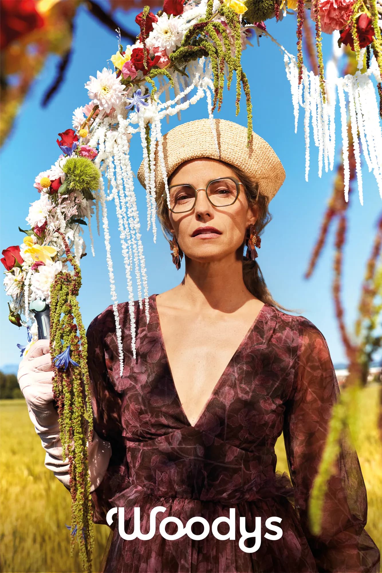 Model wearing Woodys Shona optical frames beneath a flower-covered garden arch
