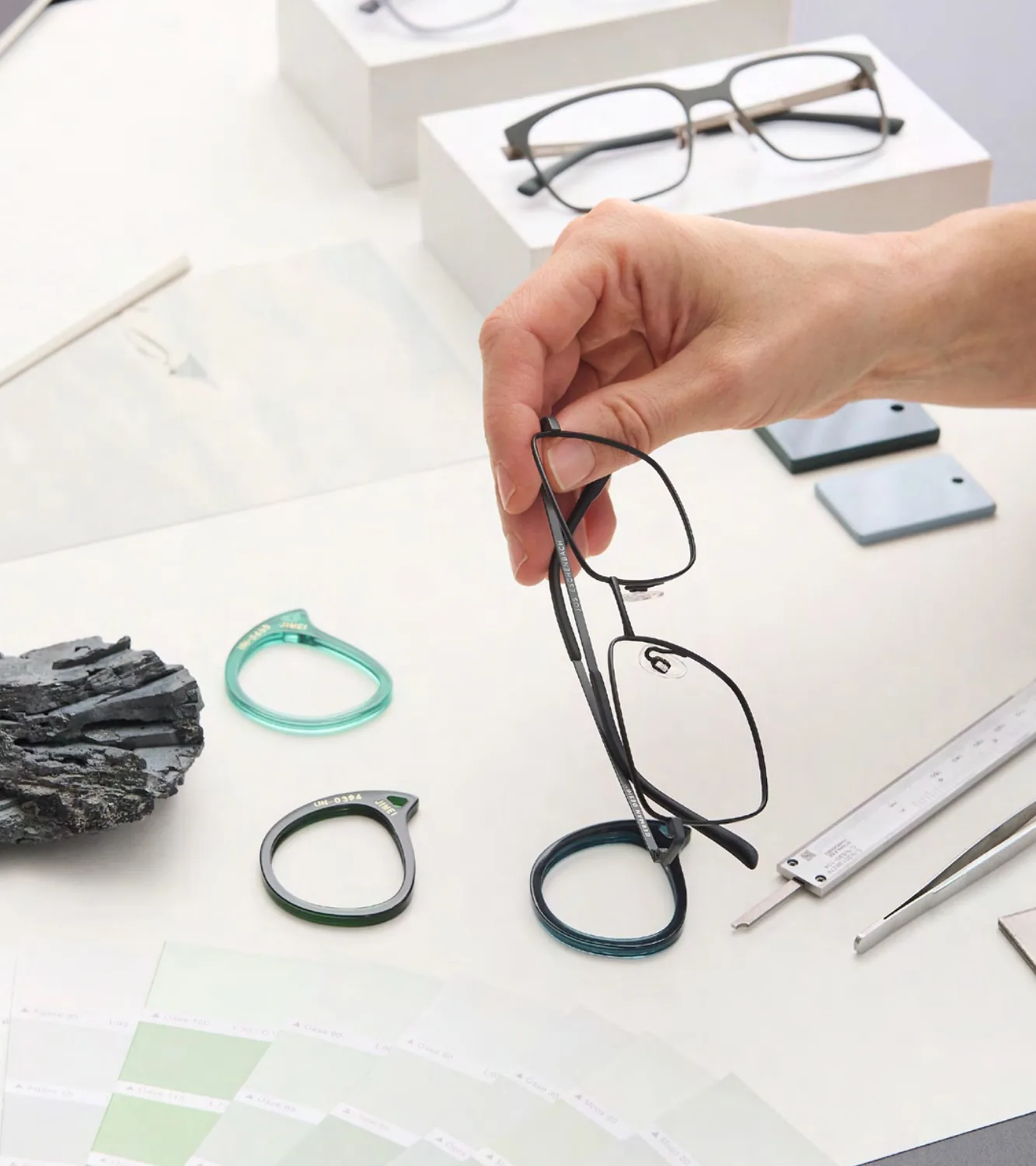 Jos. Eschenbach SS26 studio image with optical frames and material samples