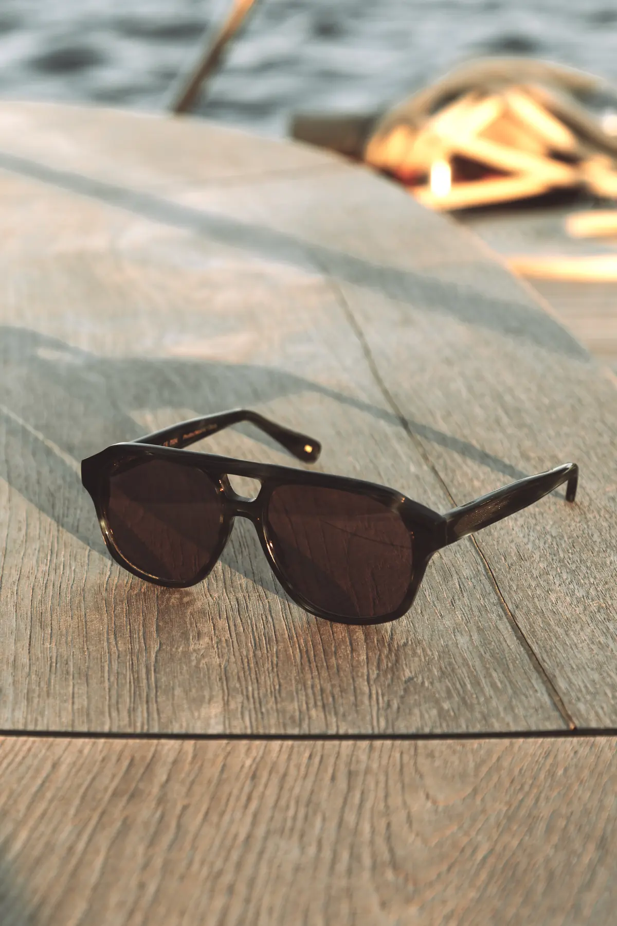 L.G.R GONE still-life image with dark sunglasses on a boat deck