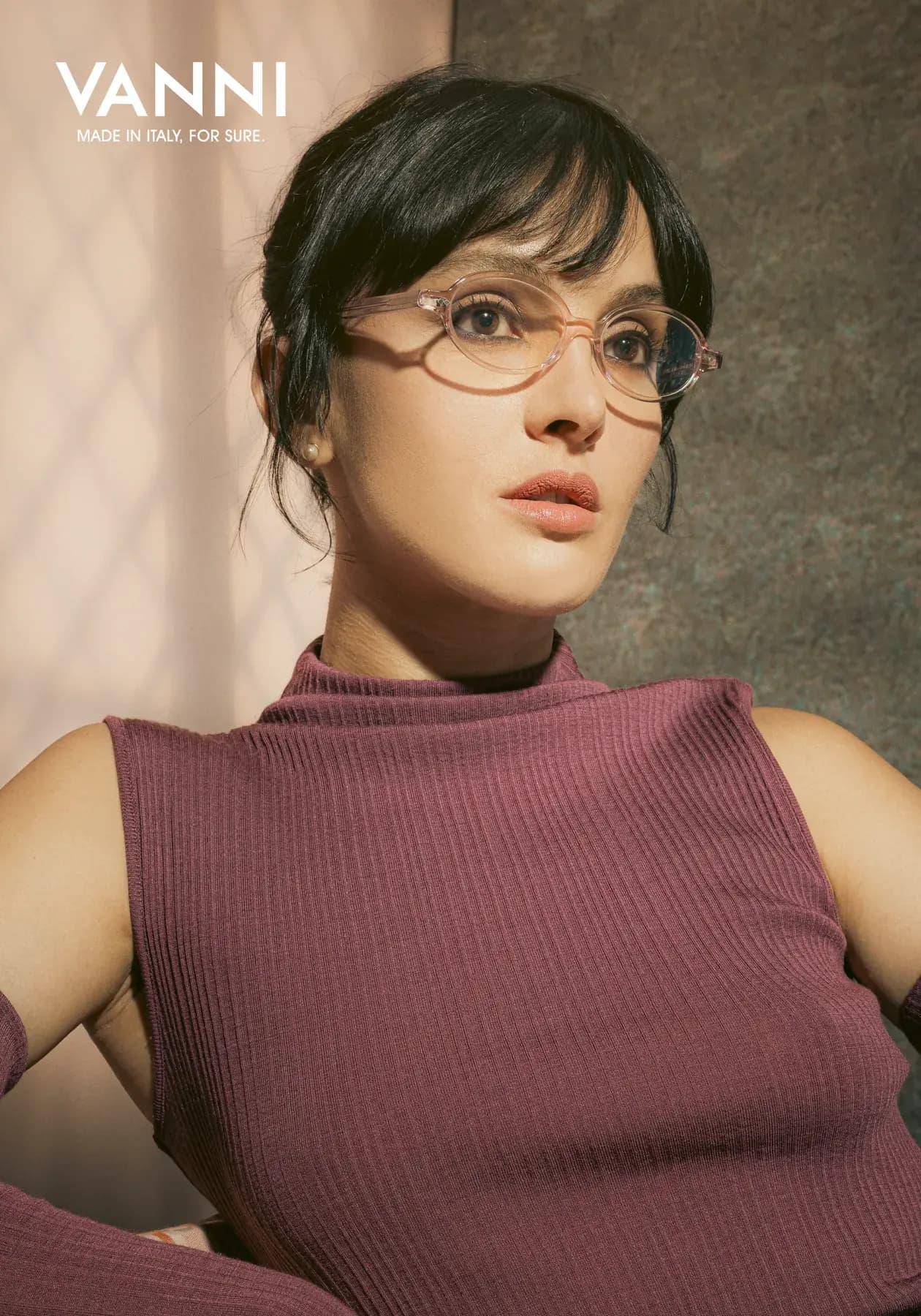 VANNI Fall/Winter 2025 optical campaign portrait with a dark-haired model wearing a translucent frame