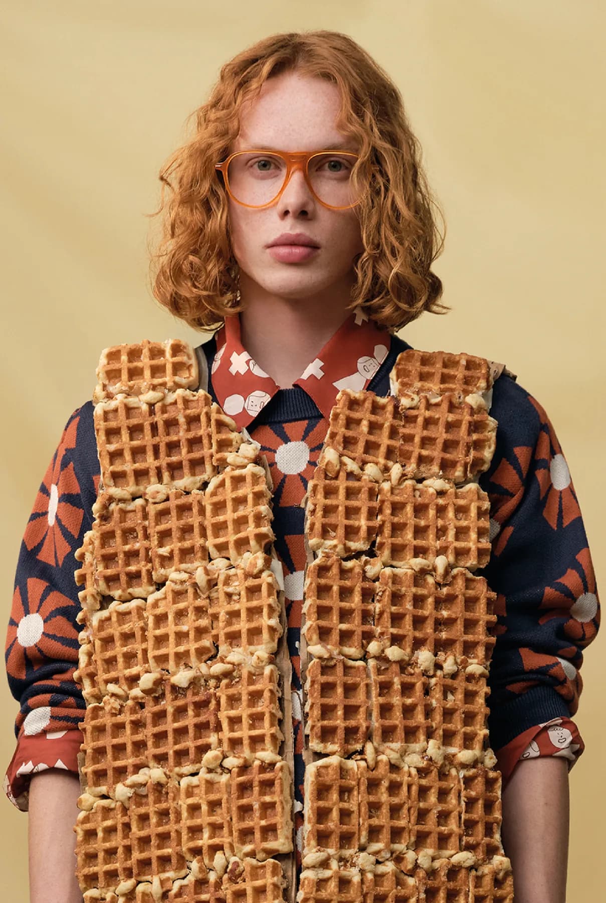 Woodys Unique Bakery SS26 optical campaign image with a model wearing an amber frame
