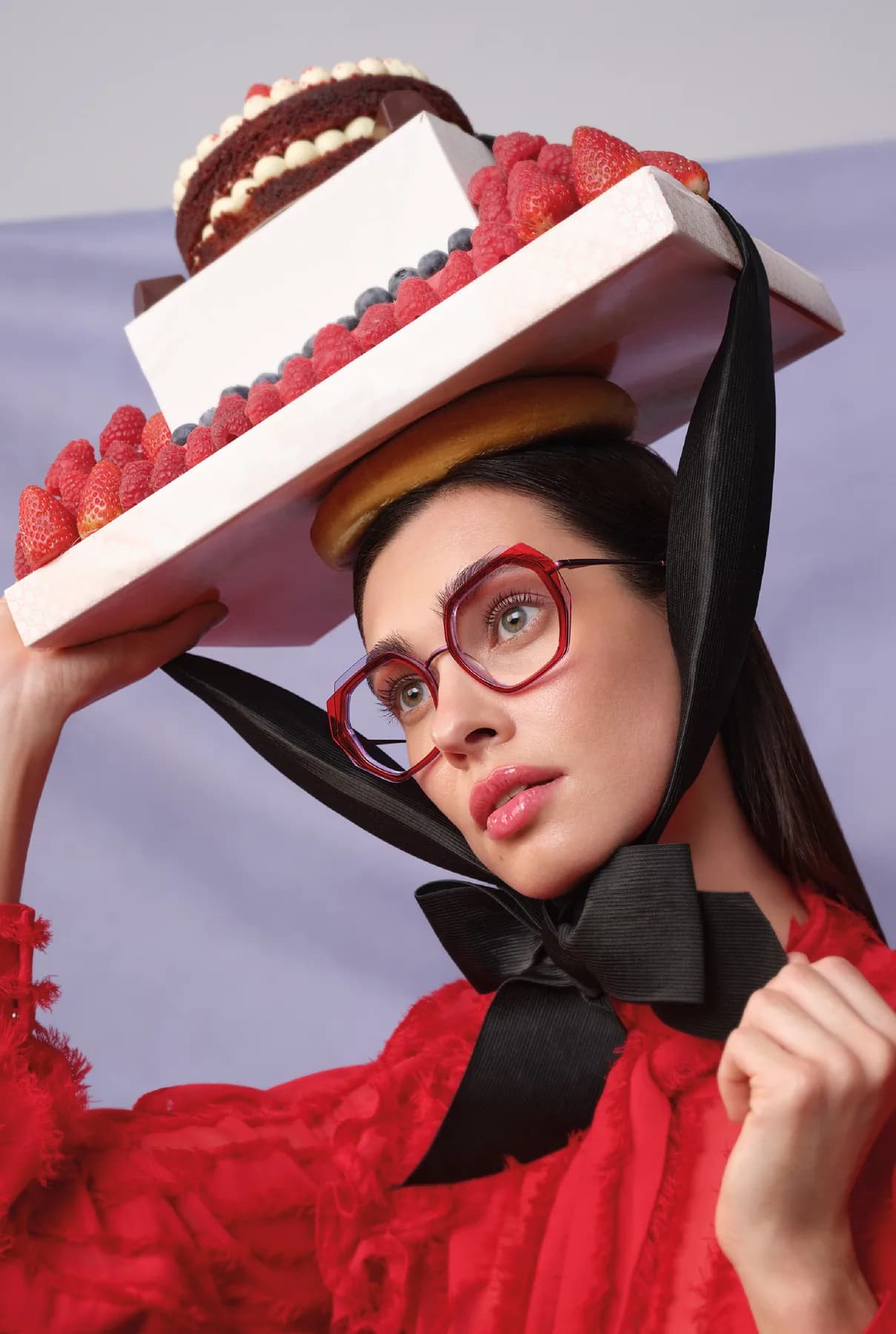 Woodys Unique Bakery SS26 optical campaign image with a model wearing a red frame